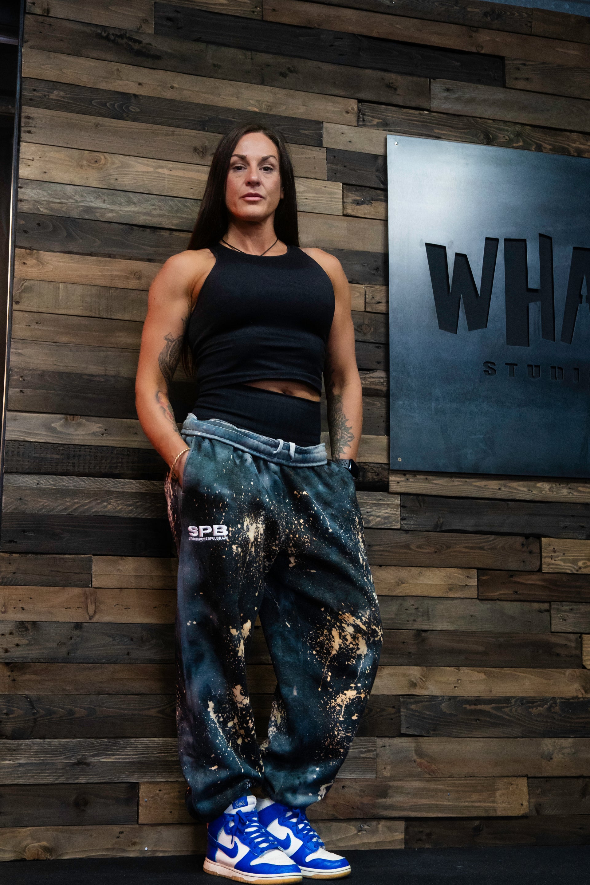 Founder Carly wearing the Super cosmic black oversized tie dye bottoms in an XL 
