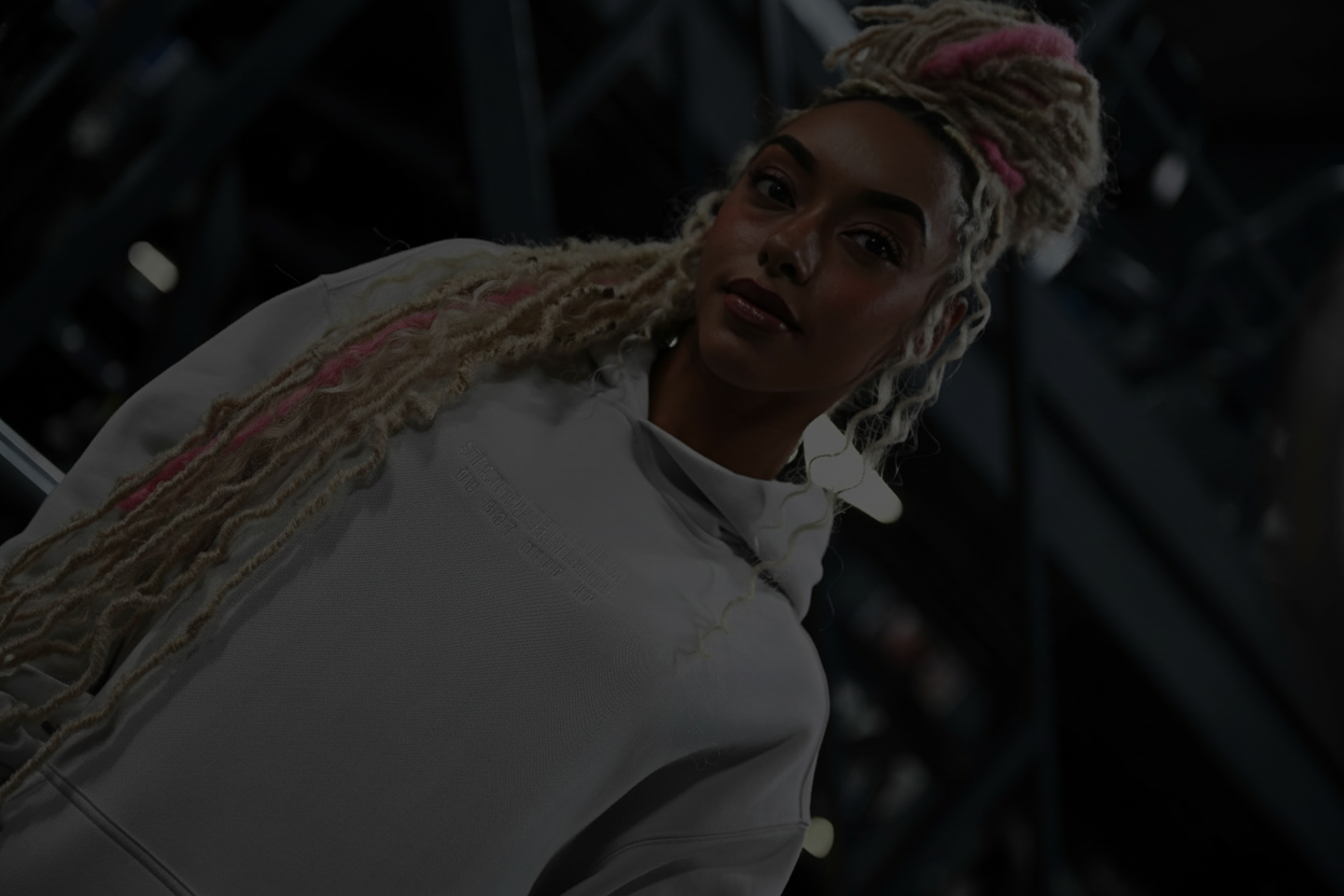 Person wearing a white jacket with a blurred background